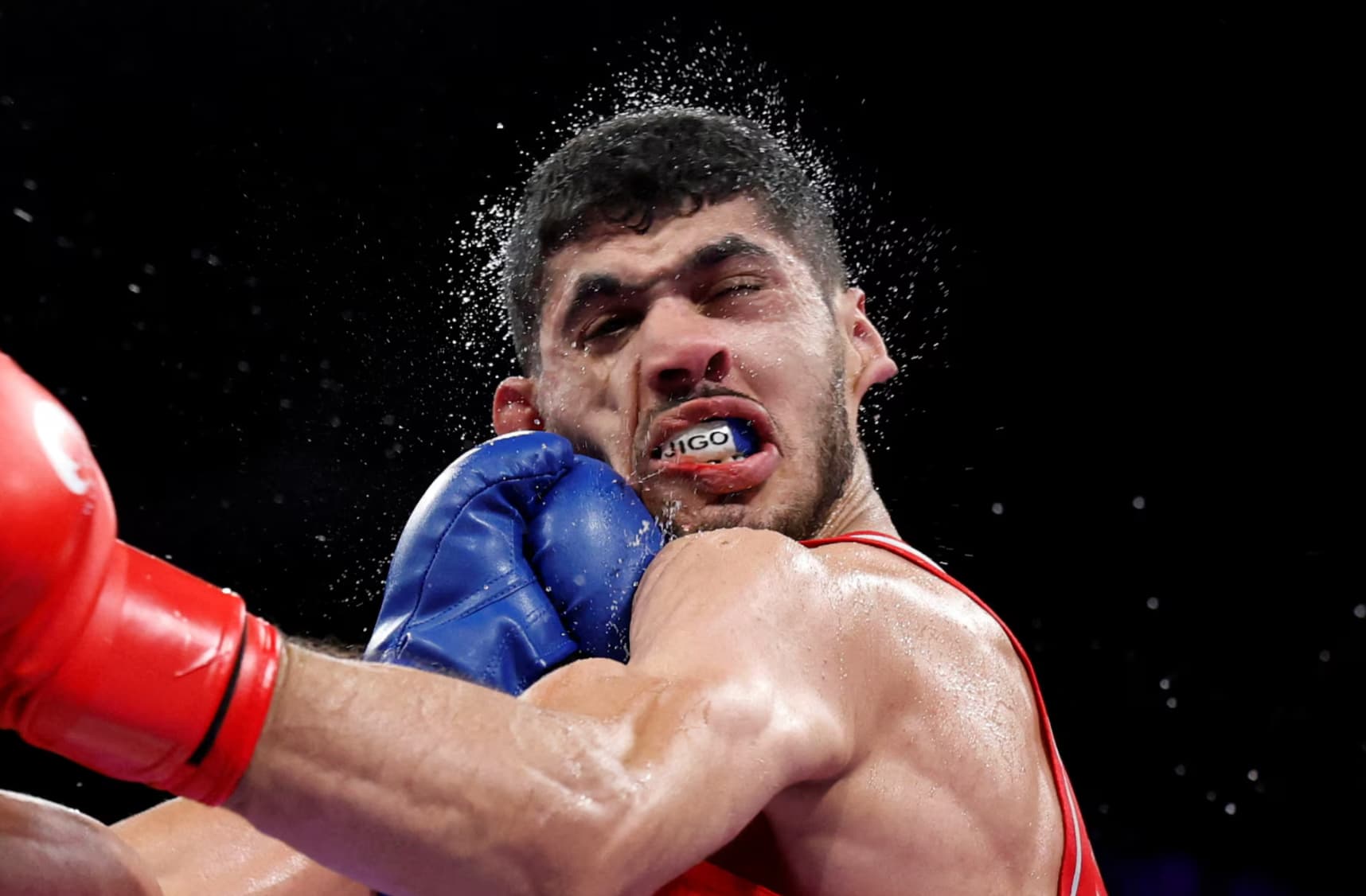 Cuban boxer Erislandy Alvarez lands a fist to the face from Algeria’s Jugurtha Ait Bekka. 